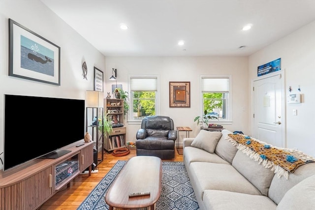 living room with plenty of natural light, light wood-type flooring, and recessed lighting