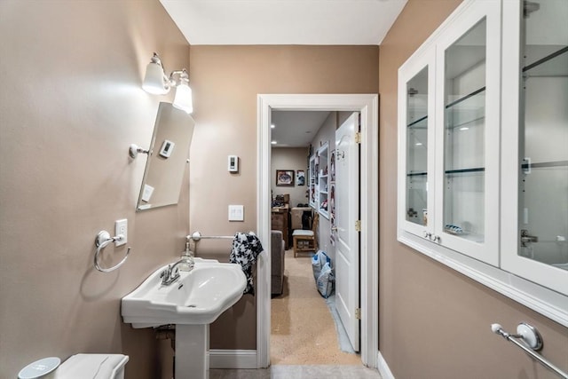 bathroom with baseboards and a sink