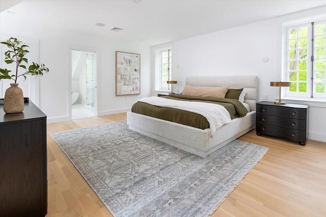 178 Ivy St, Brookline, MA 02446 - bedroom with multiple windows, light wood-style floors, baseboards, and ensuite bathroom