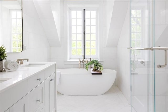 178 Ivy St, Brookline, MA 02446 - full bathroom with a soaking tub, double vanity, tile walls, and a shower stall