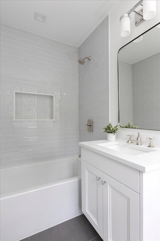 178 Ivy St, Brookline, MA 02446 - bathroom with shower / washtub combination, vanity, and tile patterned flooring