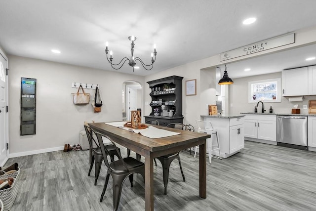 dining room with sink and light hardwood / wood-style flooring