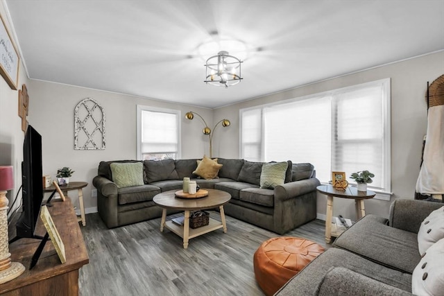 living room with wood-type flooring and a notable chandelier