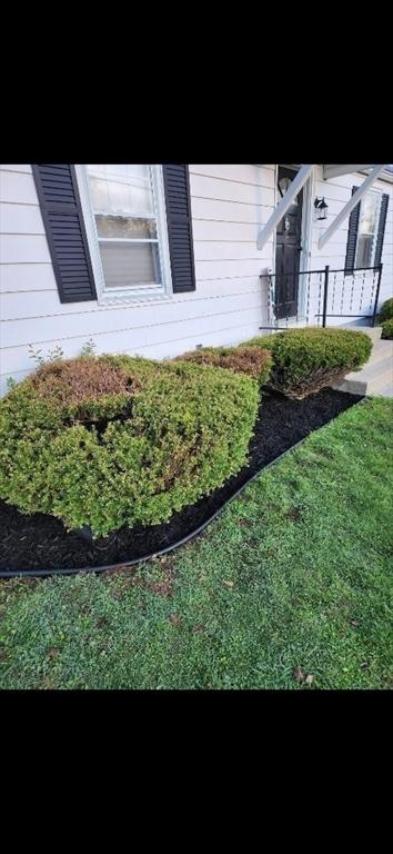 view of property exterior with a lawn