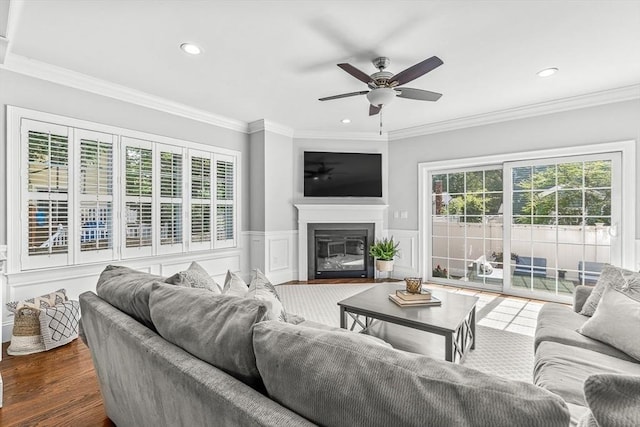 4 Fairfield Pl, Winchester, MA 01890 - living area featuring a ceiling fan, ornamental molding, dark wood-type flooring, a decorative wall, and a wainscoted wall