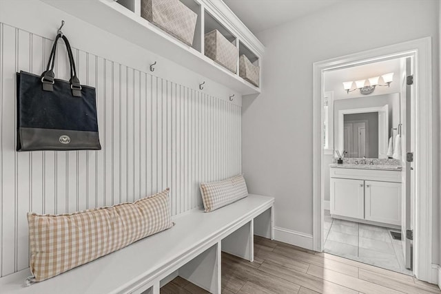 4 Fairfield Pl, Winchester, MA 01890 - mudroom featuring baseboards, light wood-type flooring, and a sink