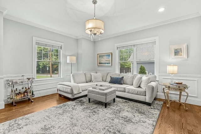 4 Fairfield Pl, Winchester, MA 01890 - living room with plenty of natural light, wood finished floors, a chandelier, wainscoting, and ornamental molding