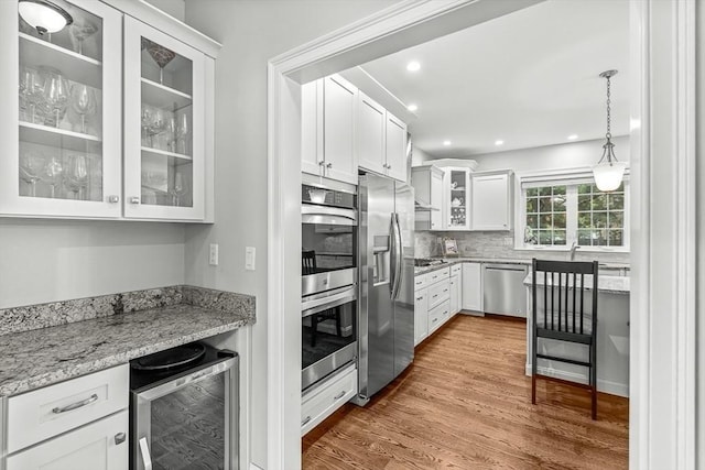 4 Fairfield Pl, Winchester, MA 01890 - kitchen with stainless steel appliances, beverage cooler, white cabinetry, dark wood-type flooring, and glass insert cabinets