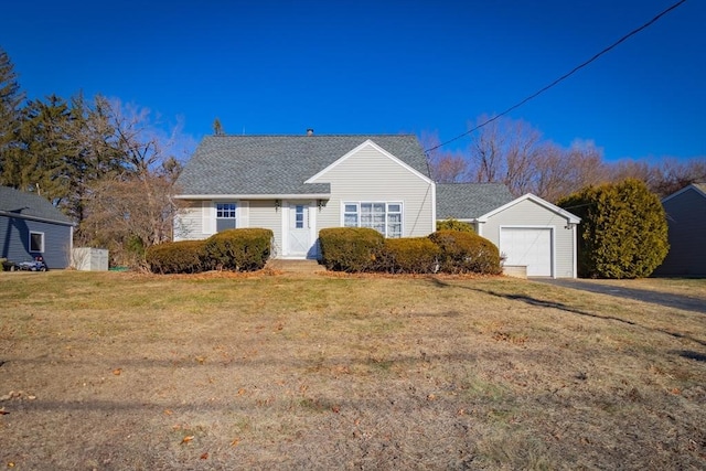 view of front of house featuring a front lawn and a garage