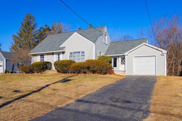 view of front of property featuring a garage and a front lawn