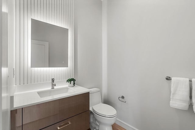 bathroom with toilet and vanity