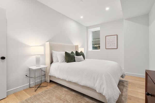 bedroom with baseboards, recessed lighting, and wood finished floors