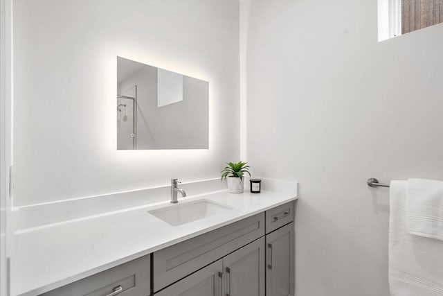 bathroom with walk in shower and vanity