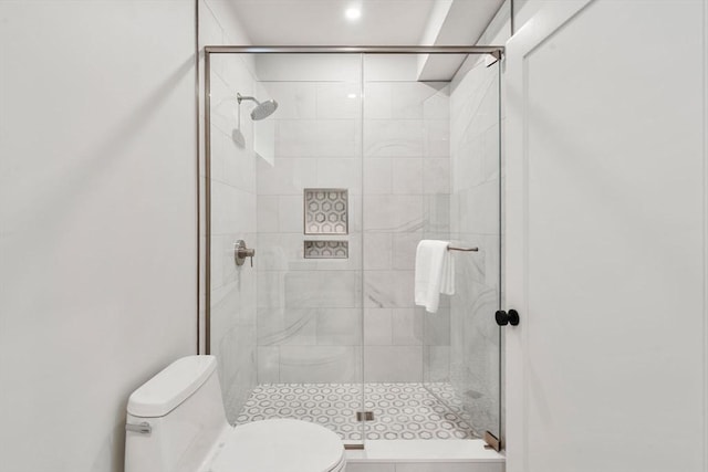 full bathroom featuring toilet and a stall shower