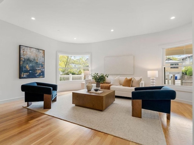 living room with light wood finished floors, a healthy amount of sunlight, and recessed lighting