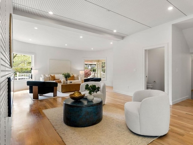 living room with baseboards, light wood finished floors, and recessed lighting