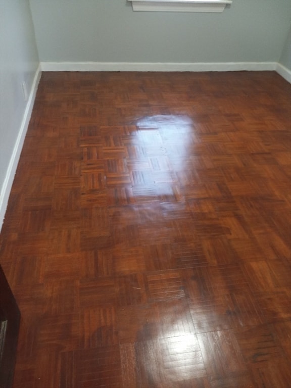 empty room with dark parquet floors