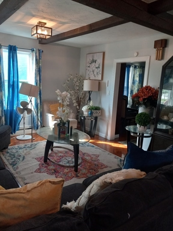 living room featuring beam ceiling and hardwood / wood-style floors