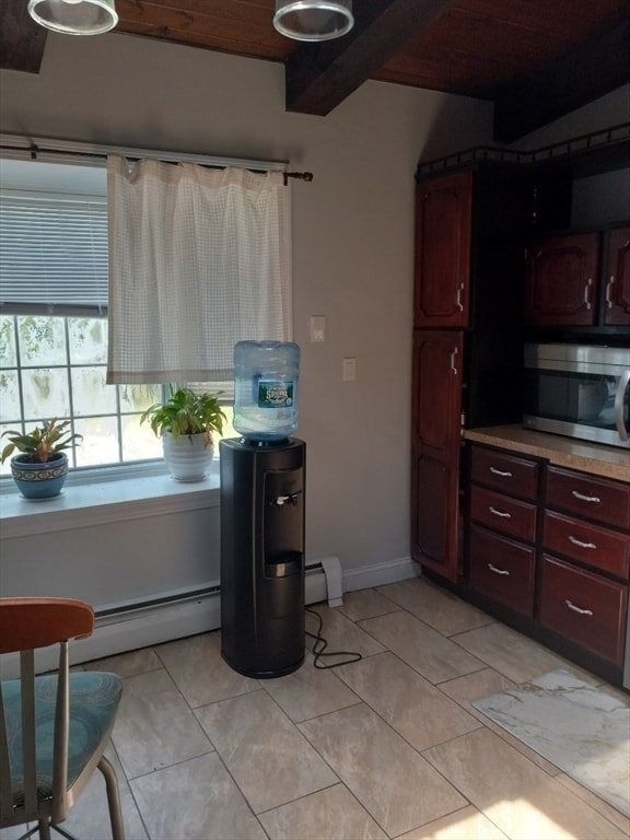 kitchen featuring a baseboard heating unit and light tile patterned floors