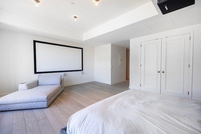 bedroom with light wood-type flooring and a closet