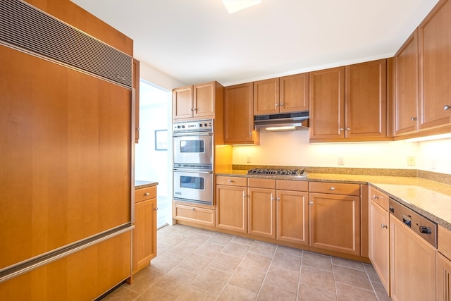 kitchen featuring appliances with stainless steel finishes and light stone countertops