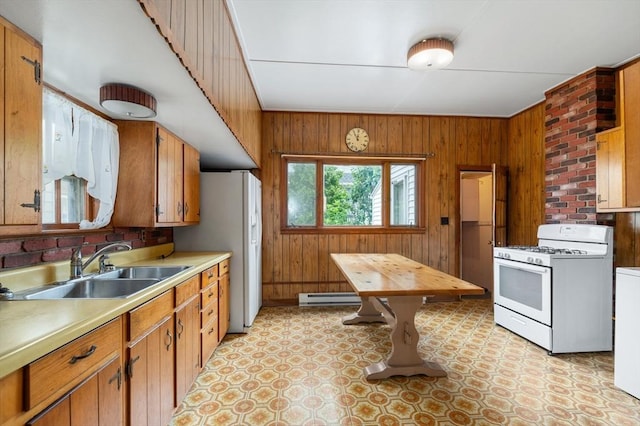 300-302 Main St, Gloucester, MA 01930 - kitchen featuring white gas range, baseboard heating, wooden walls, light countertops, and brown cabinets