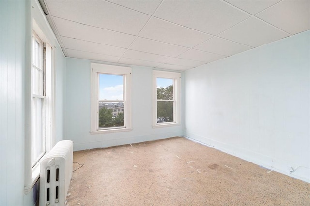 300-302 Main St, Gloucester, MA 01930 - empty room with radiator heating unit, a drop ceiling, plenty of natural light, and carpet floors