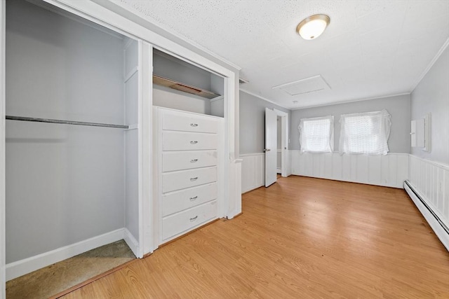 32 Standish Ave, Plymouth, MA 02360 - unfurnished bedroom with attic access, light wood-style flooring, wainscoting, baseboard heating, and ornamental molding