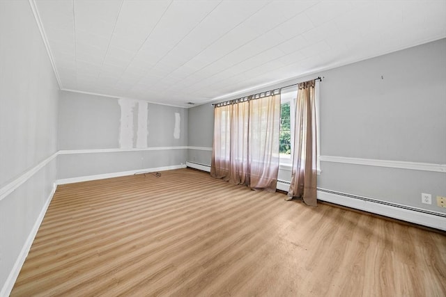 32 Standish Ave, Plymouth, MA 02360 - empty room with wood finished floors, a baseboard heating unit, and ornamental molding