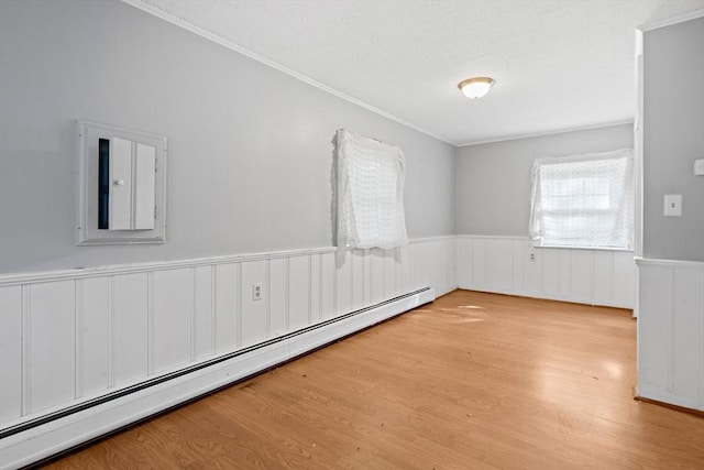 32 Standish Ave, Plymouth, MA 02360 - spare room with baseboard heating, crown molding, wainscoting, and wood finished floors