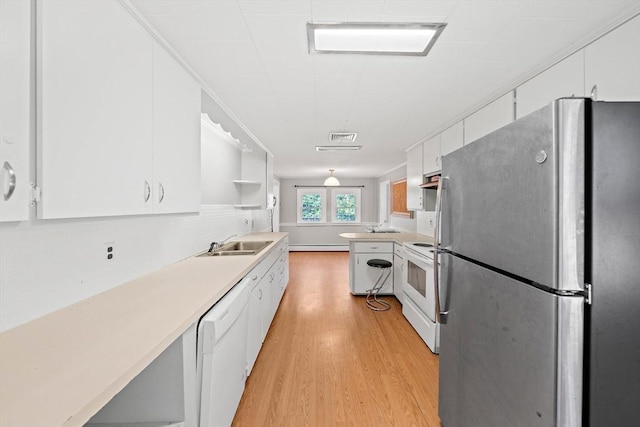 32 Standish Ave, Plymouth, MA 02360 - kitchen with white appliances, light wood-style flooring, white cabinets, light countertops, and open shelves