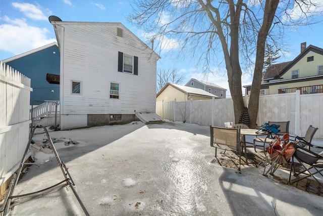 back of property featuring outdoor dining area, a fenced backyard, and a patio