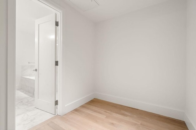 empty room featuring light wood-style floors and baseboards