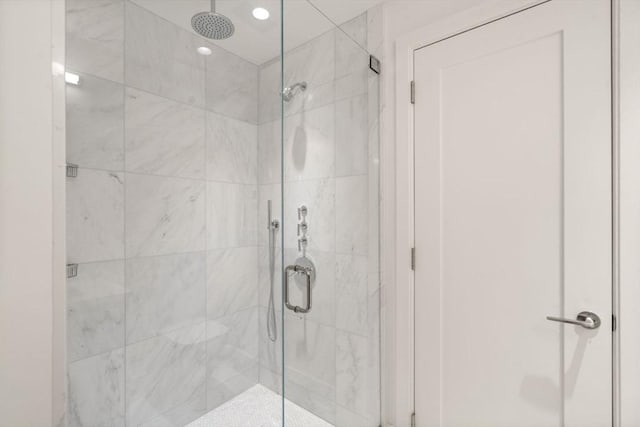 bathroom featuring a stall shower and recessed lighting