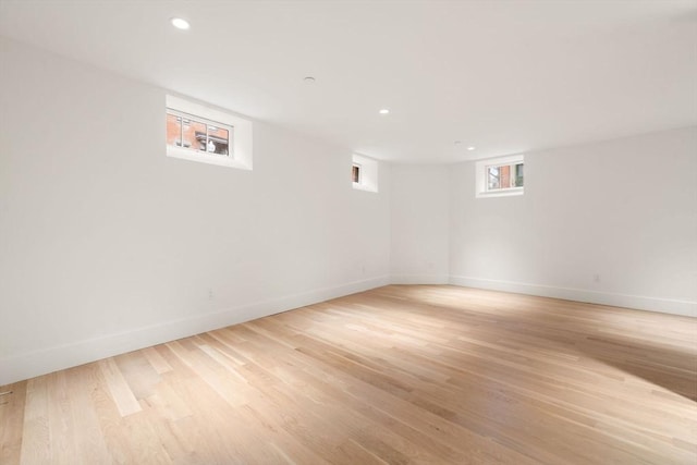 empty room with recessed lighting, light wood-type flooring, and baseboards