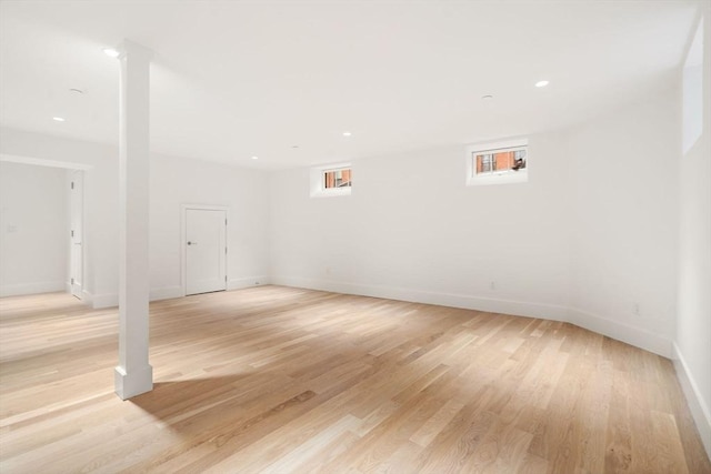 interior space with plenty of natural light, recessed lighting, light wood-type flooring, and baseboards