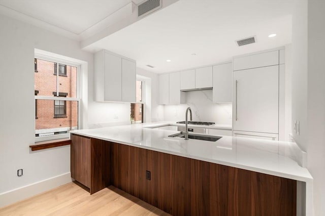 kitchen with visible vents, plenty of natural light, and a peninsula