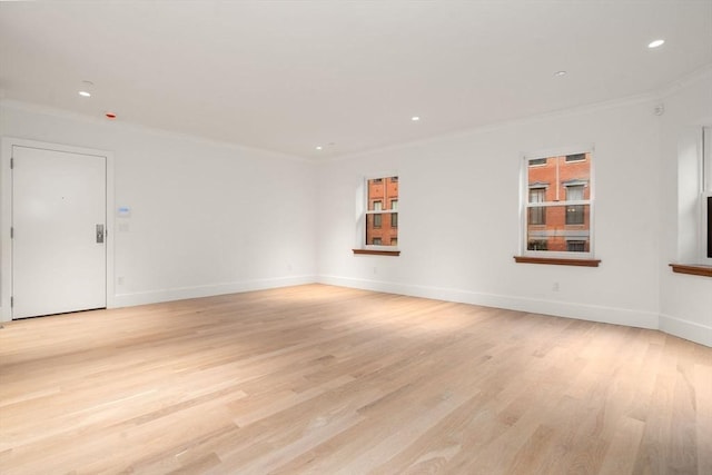 empty room featuring baseboards, recessed lighting, light wood-type flooring, and crown molding