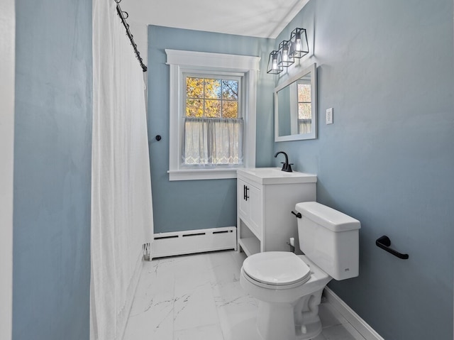 bathroom featuring vanity, toilet, and baseboard heating