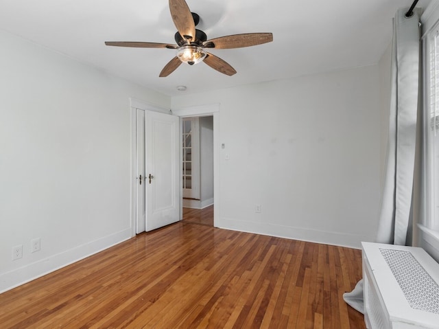 empty room featuring hardwood / wood-style flooring and ceiling fan