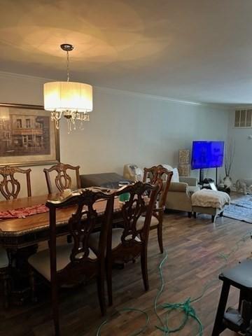 255 N Rd Unit 137, Chelmsford, MA 01824 - dining space featuring a chandelier, visible vents, wood finished floors, and crown molding