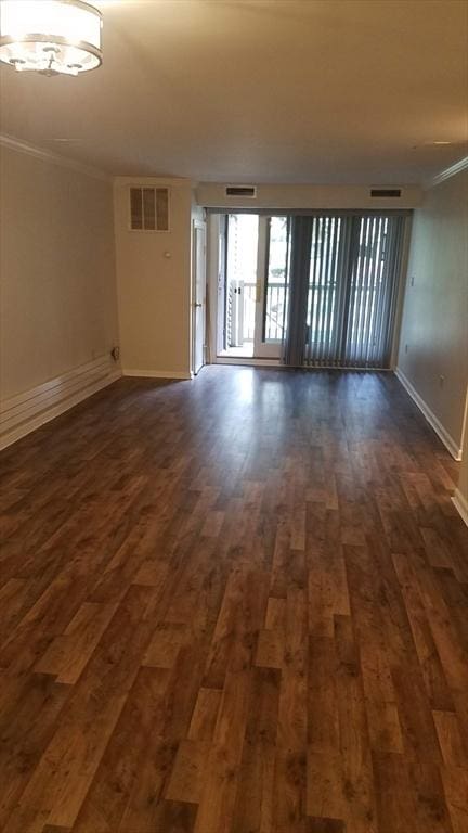 255 N Rd Unit 137, Chelmsford, MA 01824 - spare room featuring baseboards, visible vents, dark wood-style flooring, and crown molding