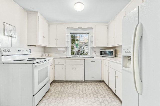 kitchen with white cabinetry and white appliances