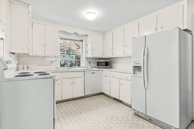 kitchen featuring white cabinetry, white appliances, and sink