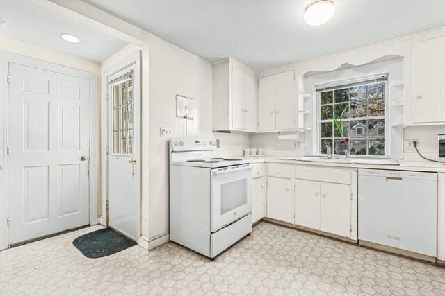 kitchen with white cabinets, white appliances, and sink