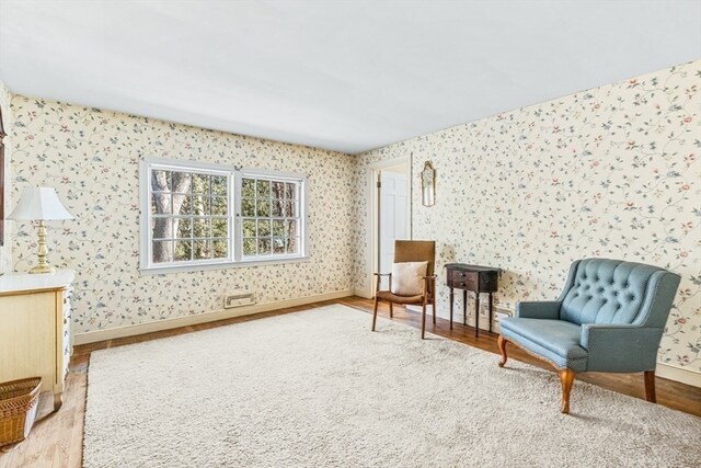 sitting room with wood-type flooring