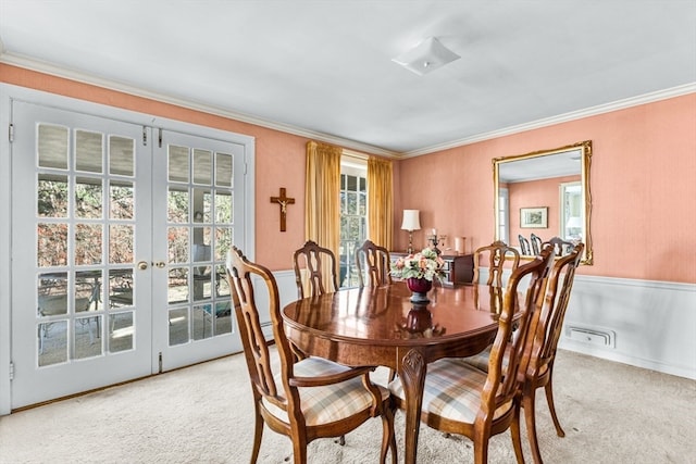 carpeted dining area with crown molding