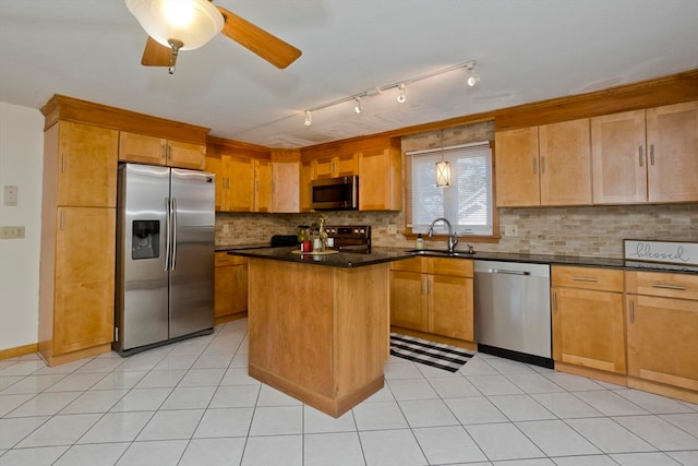 kitchen featuring tasteful backsplash, sink, a kitchen island, and stainless steel appliances