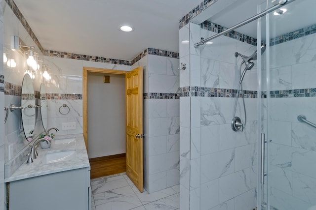 bathroom featuring vanity and a shower with door