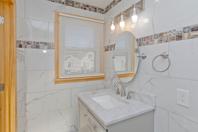 bathroom with vanity and tile walls